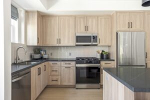 Kitchen in Kendry Montclair apartments for rent with light wood cabinets and stainless steel appliances.